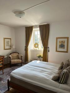 a bedroom with a large bed and a window at Hotell Dannegården in Trelleborg +78 photos