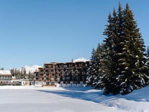 a hotel in the snow with snow covered trees at Lake Hotel Courchevel 1850 in Courchevel