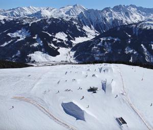 a group of people skiing down a snow covered mountain at Hotel Maria Theresia in Gerlos