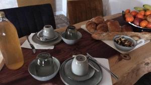 a wooden table with a plate of food on it at Aux Deux Tours in Leval