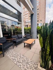 a patio with couches and a bench on a building at ibis Guarulhos Aeroporto in Guarulhos
