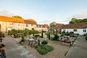 a courtyard of a building with tables and chairs at Horseshoe Cottage in Bridlington