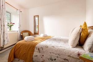 a bedroom with a bed with towels on it at Horseshoe Cottage in Bridlington