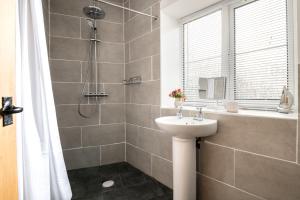 a bathroom with a sink and a shower at Horseshoe Cottage in Bridlington