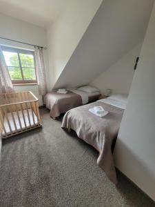 a bedroom with two beds and a window at Chata Kvilda in Kvilda