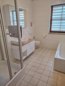 a white bathroom with a sink and a toilet at Gemütliche 100 qm Wohnung mit Balkon in Wernsdorf +9 photos
