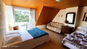 Un dormitorio con una cama y un sofá y una ventana. en Maison Martha, en Bangor
