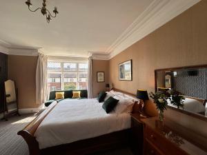 a bedroom with a large bed and a large window at Georges Place in York
