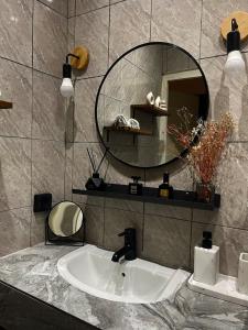 a bathroom with a sink and a mirror at Les apparts d Agathe in Brazzaville +24 photos