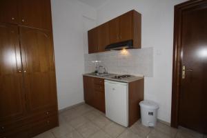 a small kitchen with a sink and a stove at PortoDream Studios & Apartments in Neos Marmaras