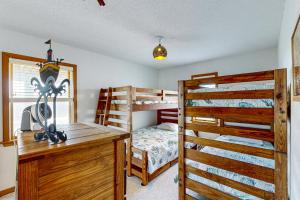 a bedroom with two bunk beds and a desk at Rogue Wave 146 in Avon +22 photos
