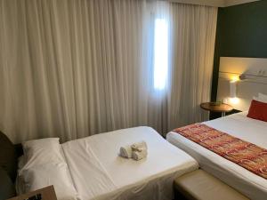Letto o letti in una camera di Quality Faria Lima