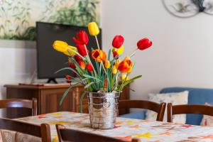 a vase of red and yellow tulips on a table at Villa Marta in Villasimius
