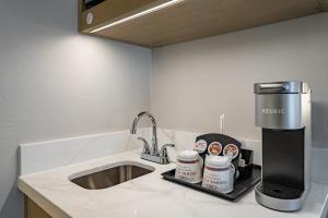 a kitchen counter with a sink and a coffee maker at Crowne Plaza Orlando-Downtown by IHG in Orlando