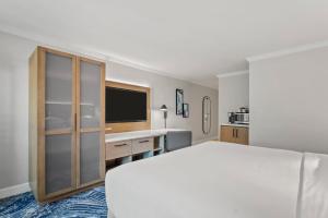 a hotel room with a bed and a television at Crowne Plaza Orlando-Downtown by IHG in Orlando