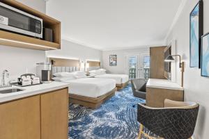 a hotel room with two beds and a kitchen at Crowne Plaza Orlando-Downtown by IHG in Orlando
