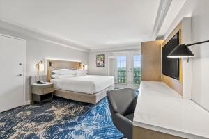 a hotel room with a bed and a chair at Crowne Plaza Orlando-Downtown by IHG in Orlando