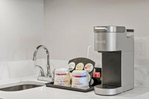 a kitchen counter with a sink and a coffee maker at Crowne Plaza Orlando-Downtown by IHG in Orlando