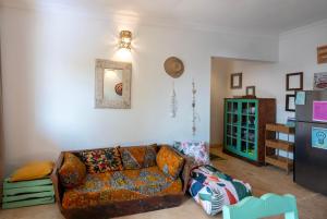 a living room with a couch and a refrigerator at FURAHA VILLA 3 in Chanjani