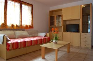 a living room with a couch and a table at Residence Milena in Milano Marittima