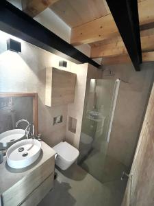a bathroom with a sink and a toilet and a shower at Casa pi in Bunyola +18 photos