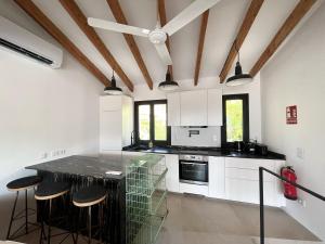 a kitchen with white cabinets and a black counter top at Casa pi in Bunyola