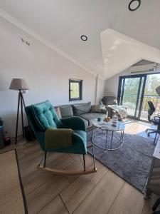 a living room with a green couch and a table at ByLotos in Side