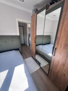 a bedroom with a mirror and a bed at ByLotos in Side