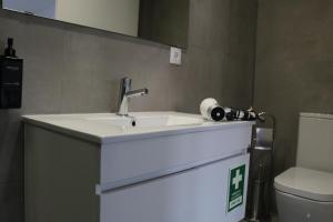 a bathroom with a sink and a toilet at 9 min Metro to Downtown -Remote working - Free Parking in Porto
