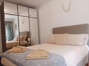 a bedroom with a bed with towels on it at Casa Susana in Atouguia da Baleia