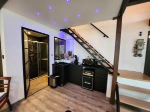 a living room with a staircase in a house at Madgic Loft in Épinal