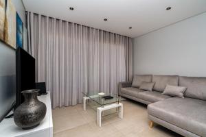 ein Wohnzimmer mit Sofa und Tisch in der Unterkunft Radiantescapadela in Estreito da Calheta