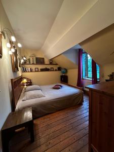 a bedroom with a large bed in an attic at Elvis presley in Raizeux