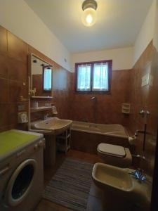 a bathroom with a tub and a toilet and a sink at Residence Milena in Milano Marittima +61 photos