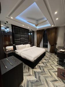 a bedroom with a large white bed in a room at Courteous Hotel in Islamabad +291 photos