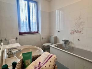 a bathroom with a tub and a toilet and a sink at Villino Rita in Portoferraio