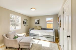 a bedroom with a bed and a chair at Less Than 1 Mi to Olde Town Arvada Home with Patio! in Arvada
