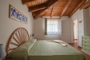 a bedroom with a large bed in a room with wooden ceilings at Charming Sea Villa shared pool Sleeps 6 V6IN in Cuile Pazzoni +40 photos