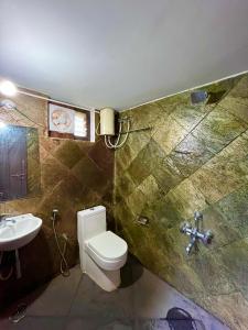 a bathroom with a toilet and a sink at Sabera Heritage Homestay in Sakleshpur