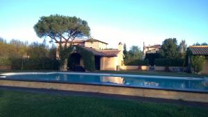 a swimming pool in the yard of a house at Casale DI Tormaggiore Villa And Country Suites in Pomezia
