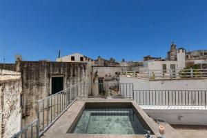 a swimming pool on the roof of a building at Suite Princess Sophie in Ostuni