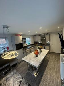 a large kitchen with a table in the middle at Stunning 3-Bedroom in Alford Lincolnshire in Alford