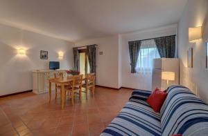 a living room with a couch and a table at Charming Small Villa shared pool Sleeps V4IN in Cuile Pazzoni