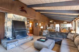 a living room with a large stone fireplace at Bird's Eye View in Yosemite West +19 photos