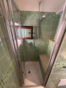 a bathroom with a shower with a shower at TINY HOUSE in the HEART of TAORMINA in Taormina