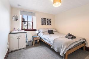 a bedroom with two beds and a sink in it at Keith - Spacious 4 bed house in Keith +20 photos