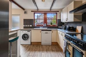 a kitchen with a washer and dryer in it at Keith - Spacious 4 bed house in Keith