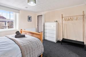 a bedroom with a bed with a teddy bear on it at Keith - Spacious 4 bed house in Keith
