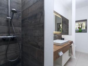 a bathroom with a shower and a sink at Ferienwohnung Tannen Suite in Waren +10 photos