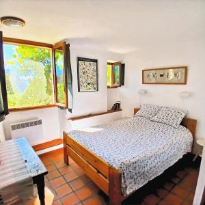 a bedroom with a bed and a window at Gorges du Verdon - Chambres d'Hotes des arches - Cadre magnifique, in Castellane